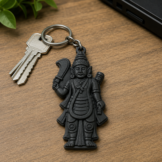 A black metal keychain featuring a detailed warrior figurine, shown with two silver keys on a wooden tabletop.